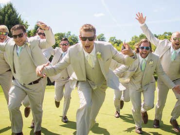 The groomsmen and groom have a laugh during their wedding photoshoot at the A Ga Ming Golf Resort in Kewadin, Michigan.