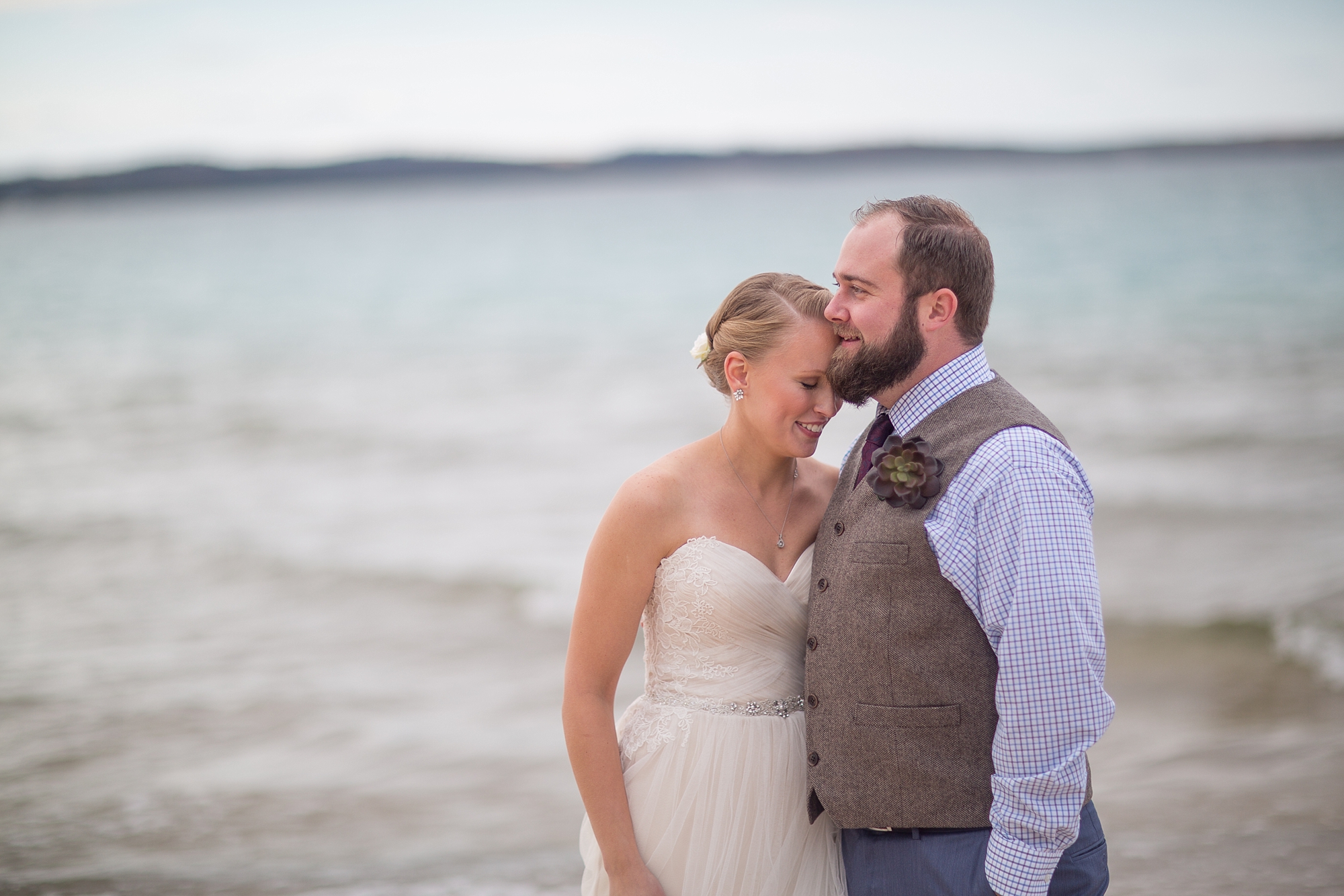 Couple Cuddles on the shores of Lake Michigan at the Homestead Resort