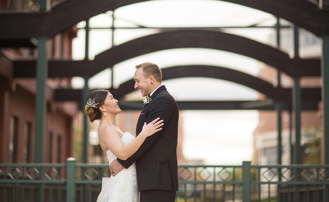 Hugging During their Downtown Kalamazoo, Michigan Wedding Day Romantic Couples Session