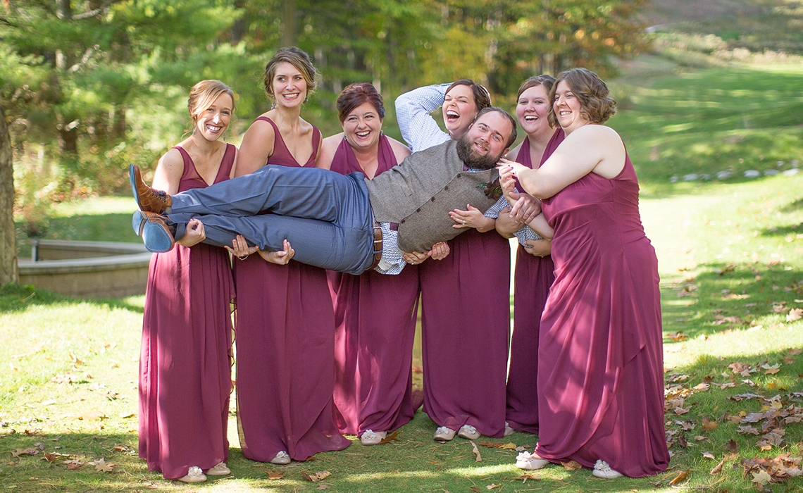 The groom and bridesmaids have a laugh during this destination wedding in Northern Michigan