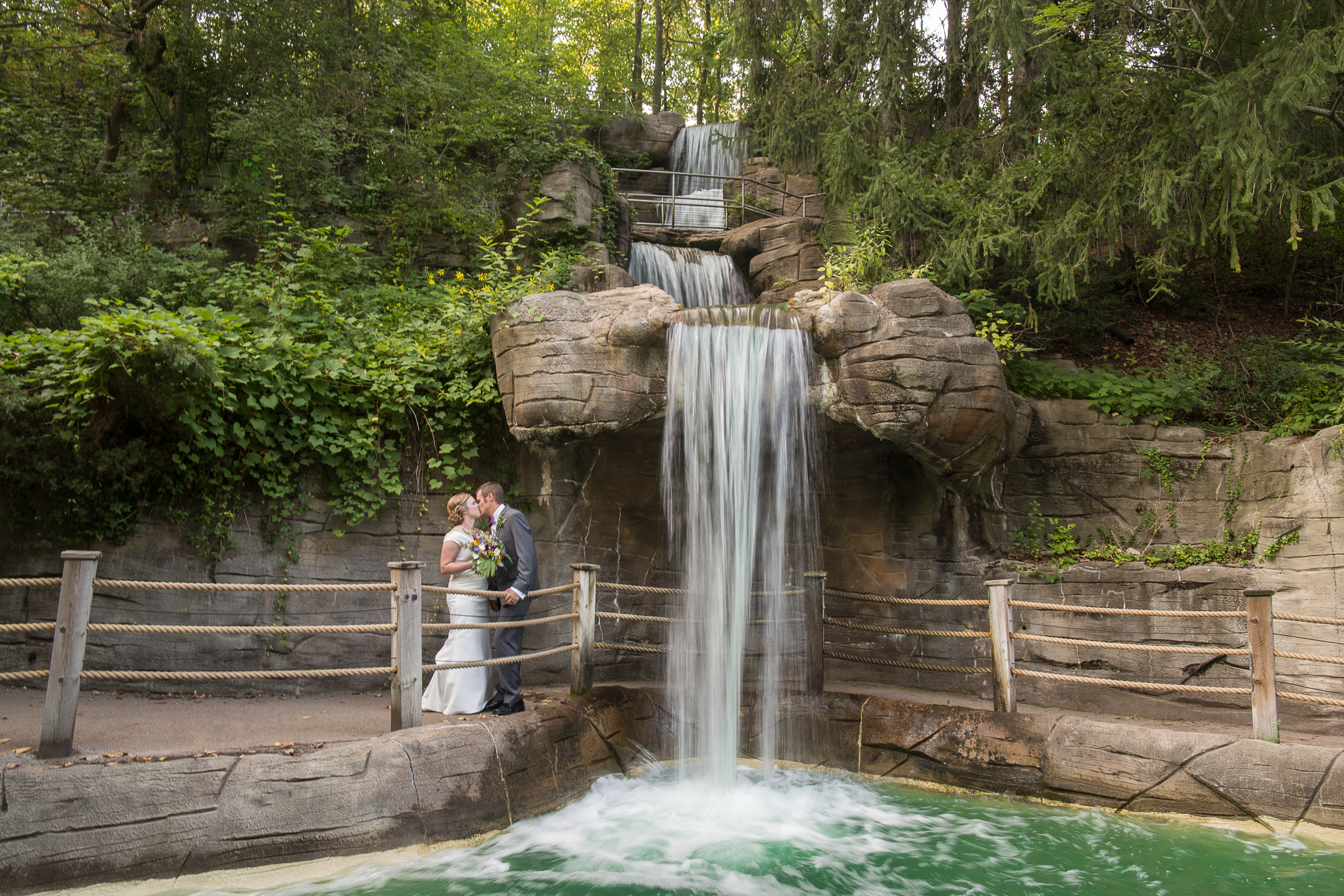 Elise & Chris stand under a waterfall on their wedding day