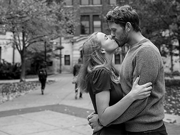 Nicole & Nicholas kiss blissfully unaware of the hustle and bustle around them on the University of Michigan College campus in Ann Arbor, Michigan